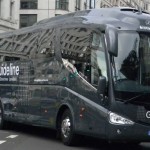An image of a coach from Guideline Coaches Ltd driving through London