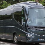 An image of a Guideline Coaches coach driver, driving a coach