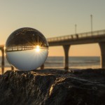 An image of the Brighton pier with the sunset in the background.